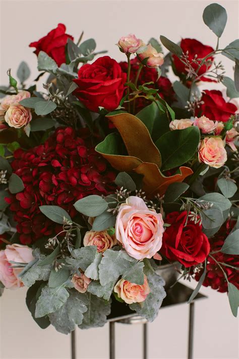 Something borrowed blooms - The Nina Collection embodies the essence of a romantic western sunset with its warm and dreamy color palette. Featuring a variety of terracotta and light pink open dutchess roses, dusty lavender, and rust ranunculus, and dark plum apple blossom sprays arranged together beautifully. 
